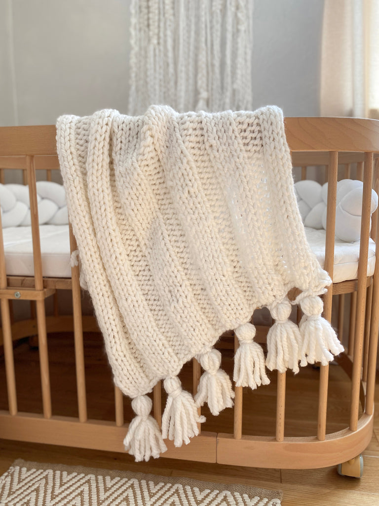 Boho knitted white baby blanket by Anzy home. baby shower gift for baptism or pregnancy congrats, for newborn photo props or as an expecting mom gift box.
